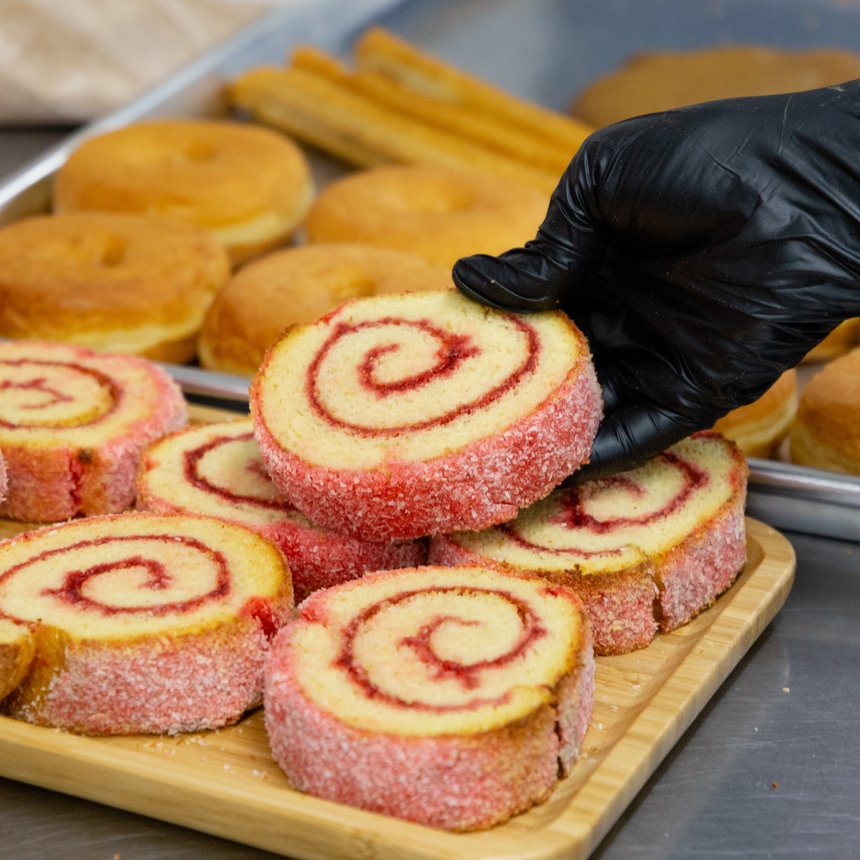 Strawberry swirl roll slices in coconut sugar — Korner Market panadería